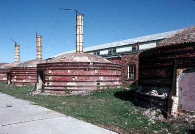 General view of Medalta Potteries, showing the beehive kilns with their brick exteriors, roof monitors, and roofing of wood shingles. (© Parks Canada Agency / Agence Parcs Canada.)