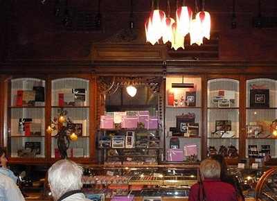 Interior view of Rogers Building, showing original surviving interior fixtures and decorative detailing, including glass-fronted cabinets and curve-topped glass counters, 2011. © Parks Canada Agency / Agence Parcs Canada, Andrew Waldron, 2011.
