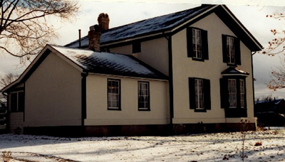 Rear view of Bell Homestead, showing its stucco finish, 1997. © Parks Canada Agency / Agence Parcs Canada, James De Jonge, 1997.