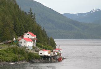 General view of Boat Bluff Lighthouse and related buildings showing the setting of the complex surrounded by water and rugged forest of Nothwest Pacific, 2011. (© Kraig Anderson - lighthousefriends.com)