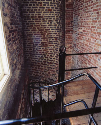 Interior view of Fisgard Lighthouse, showing the the quality and workmanship of original materials, particularly the original fabric cast iron staircase in the tower, and the interior brickwork. © Ian Doull, Parks Canada Agency, 2010  / Ian Doull, Agence Parcs Canada, 2010