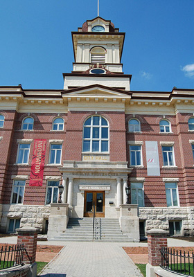 General view of St. Boniface City Hall, showing its red brick exterior facing materials contrasted with rusticated masonry basement and  buff limestone trim, 2010. © St. Boniface City Hall, AdolfGalland, May 2010.