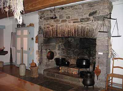 Interior view of Maison Saint-Gabriel, showing one of the large, stone fireplaces, 2005. © Parks Canada Agency / Agence Parcs Canada, N. Clerk, 2005.
