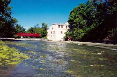 General view of the Légaré Mill, showing the viewscapes from the complex to the Rivière du Chêne, 1999. © Parks Canada Agency / Agence Parcs Canada, 1999.