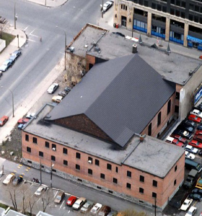 Aerial view of the armoury, showing its irregular plan and massing, consisting of two, two-storey blocks joined by a drill hall. © Regimental Museum.
