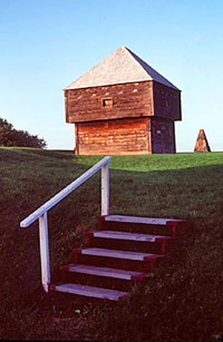 General view of Fort Edward showing the blockhouse and cairn in the background, emphasizing the cultural landscape of Fort Edward, 1983. © Parks Canada Agency / Agence Parcs Canada, F. Cattroll, 1983.