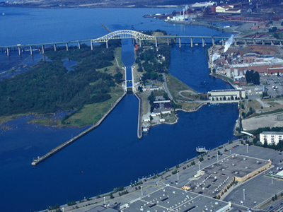 Aerial view of Sault Ste. Marie Canal showing the engineering works, buildings and designed landscape features. © Parks Canada Agency / Agence Parcs Canada.
