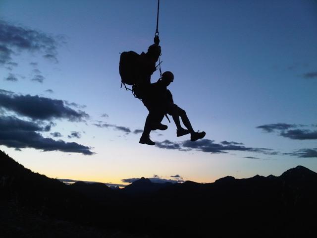 Parks Canada Visitor Safety Specialists heli-slinging as darkness falls.