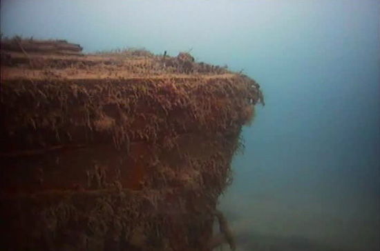 Underwater image of HMS Investigator showing the bow with a hawsehole in the upper portion of the hull