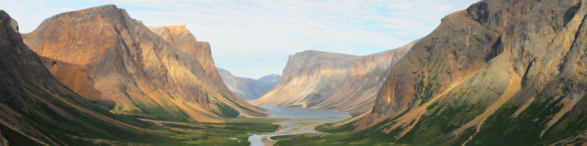 A view of a valley with a river going through some mountains in Tongait KakKasuangita SilakKijapvinga-Torngat Mountains National Park