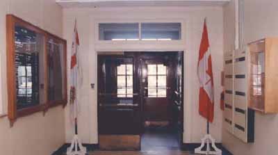 Interior view of Building S-17, showing the wooden doors of the main entrance. © Department of National Defence / Ministère de la Défense nationale.