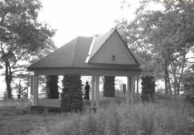 General view of the Gordon Island Pavilion, showing the decorative exposed rafter ends and the low wooden railing, 1992. © Archeological Services and Historica Resources Ltd., 1992.