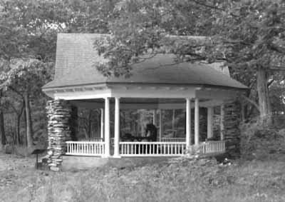 Side view of the Gordon Island Pavilion, showing the medium-pitched, octagonal roof structure supported by an articulated box beam, which in turn, is supported at the perimeter by slender paired wooden Doric columns, 1992. © Archeological Services and Historic Resources Ltd., 1992.