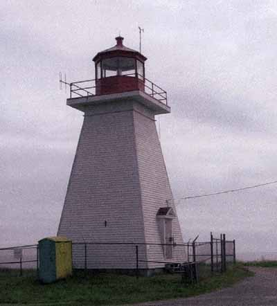 General view of Baccaro Point Lighthouse, showing its simple square, tapered profile and good proportions, 2004. (© Parks Canada Agency/Agence Parcs Canada, 2004.)