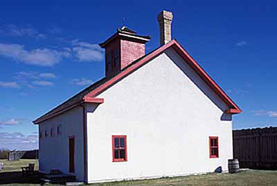 Corner view of the rear of the Sick Horse Stable, showing the gable roof and gable roofed lantern, 2003. © Parks Canada Agency / Agence Parcs Canada, M. Fieguth, 2003.