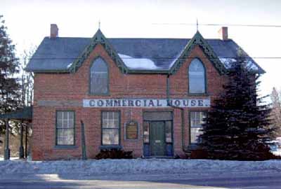 Exterior view of the Former Commercial Hotel, showing the physical references to its former functions, including the painted sign “Commercial Hotel” marking its front façade, 2005. © Public Works and Government Services Canada / Travaux publics et services gouvernementaux Canada, 2005.
