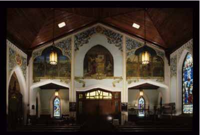 General view of St. Jude's Anglican Church, showing a series of painted murals around the nave presenting events in the life of Jesus Christ. © Parks Canada Agency/ Agence Parcs Canada.