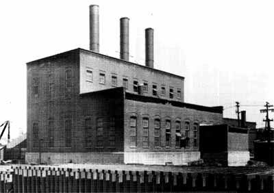 General view of the Ottawa Electric Railway Company Steam Plant from the northwest, showing the stepped massing, which is composed of a one-storey and two-storey block with a small addition to the west, 1958. © COA, OER Collection, CA-15021, 1958.