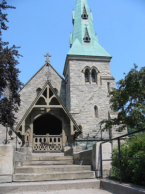 General view of Chapel of St. James-the-Less, showing the deep entrance porch, with its steeply pitched roof, low eaves, and intricate woodwork, 2006. © Chapel of St. James-the-Less, Alan Brown, July 2006.