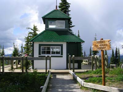 Front view of the building, from the west, showing exterior covering of wooden shingles and clapboard, surmounted by a smaller square cupola, with windows. © Parks Canada Agency/Agence Parcs Canada , 2011
