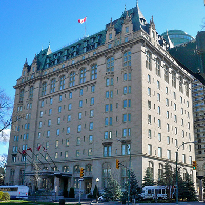 General view of Fort Garry Hotel, showing its Chateau style, evident in its steeply pitched, truncated hip roof, punctuated by multiple peaks, 2010. © Fort Garry Hotel, Adam Taves, 2010.
