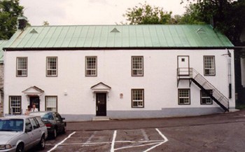 View of the exterior of Building 2, showing the two-storey massing with a sheet copper shed roof, 1993. © Parks Canada Agency / Agence Parcs Canada, Jocelyne Cossette, 1993.