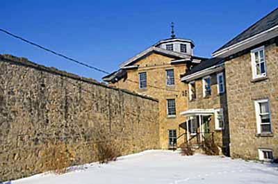 Exterior view of the Huron County Gaol, showing the two-storey-high walls, 1995. © Parks Canada Agency / Agence Parcs Canada, J. Butterill, 1995.