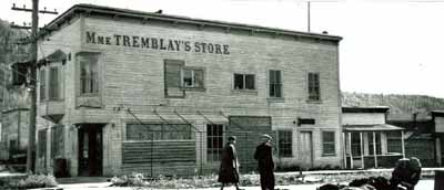 Corner view of Mme. Tremblay's Store, showing the projecting lettering spelling out the name “Mme Tremblay’s Store”, 1948. © Library and Archives Canada / Bibliothèque et Archives Canada, 1948.