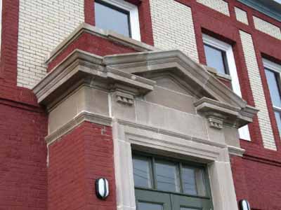 View of the Cable Building, showing the entrance with triangular pediment, 2006. © Parks Canada Agency / Agence Parcs Canada, N. Miquelon, 2006.