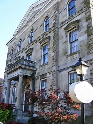 Detail view of Niagara District Court House, showing classical details, such as the corner quoins, pediment, stringcourses, and porch with columns, 2010. © Old Niagara Court House, Sean Marshall, October 2010.