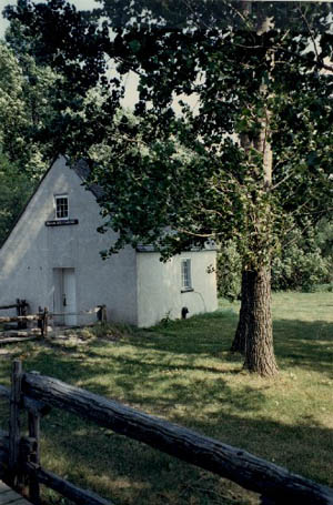 Corner view of the French People's House, showing its stone construction with crépi covered exterior walls, 1991. © Parks Canada Agency / Agence Parcs Canada, Christine Chartré, 1991.