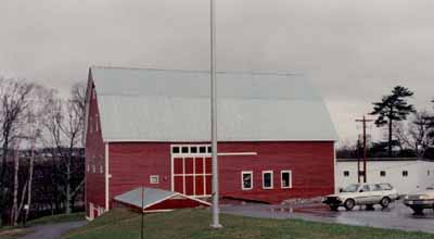 Side view of the Research Station, showing the narrow-gauge red-painted clapboard with contrasting white-painted trim and metal roofing, 1993. © Agriculture Canada / Ministère de l'Agriculture, 1993.