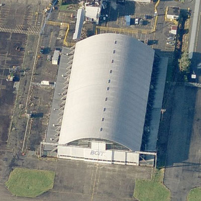 Arial view of the BCIT Hangar, Building T-131, showing its well-balanced massing, with a large, vaulted aircraft bay flanked on both sides by symmetrical one-storey administrative blocks, 2011. (© Microsoft Bing Maps, 2011.)