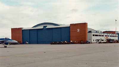General view of Hangar 2 demonstrating the high, wide doorways that span its east and west elevations, the raised central sections for particularly high aircraft, and the brick pylons at each end, 2000. (© Department of National Defence / Ministère de la Défense nationale, 2000.)