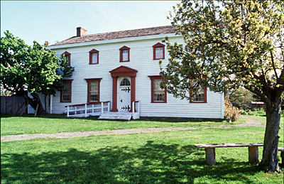 General view of Craigflower Manor House showing the prominent position of the house on a grassy knoll. © Parks Canada Agency / Agence Parcs Canada.