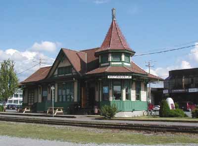 View of the Acton Vale Railway Station Grand Trunk), showing the low massing under a lively roofline including gables and a turret, 2002. (© Agence Parcs Canada / Parks Canada Agency, 2002.)