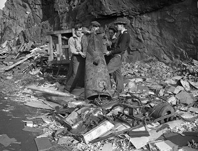 Damage to the Scotia Pier caused by a torpedo fired by the German submarine U-518 on 2 November 1942. Bell Island, Newfoundland, 3 November 1942. (© Lt Gerald M. Moses / Canada. Dept. of National Defence | Ministère de la Défense nationale / Library and Archives Canada | Bibliothèque et Archives Canada / PA-188854)