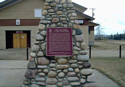 The cairn and HSMBC plaque for Fort Assiniboine NHS. The legion building is behind the cairn. © Parks Canada / Parcs Canada, 1989