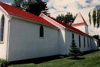 Side view of the chapel, showing the regularly arranged tall, pointed windows, 1986. © Royal Canadian Mounted Police / Gendarmerie royale du Canada, 1986.
