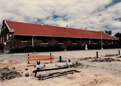 View of the Drill Hall, showing the the building’s brick wall exterior, 1986. © Gendarmerie royale du Canada | Royal Canadian Mounted Police, 1986.