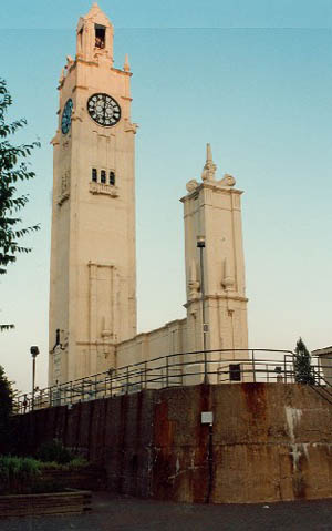 View of the Clock Tower, showing the principal tower on a square base crowned with an observation deck, a smaller tower, and a curtain wall linking the two, 1996. © Parks Canada Agency / Agence Parcs Canada, Christiane Lefebvre, 1996.
