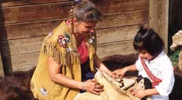 Métis Interpreter Bev Weber explaining traditional Métis art to Jaylyn Anderson (4 yrs old). Rocky Mountain House National Historic Site of Canada