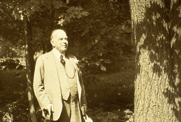 Photo of William Lyon Mackenzie King walking in woods