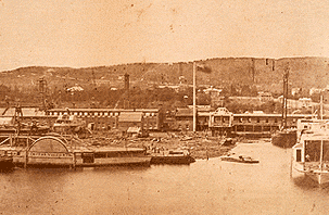 Photography showing the works, a ship, a basin and Mount Royal in the background