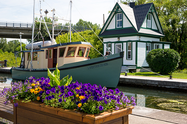 a boat on the Chambly Canal, and a little lockhouse in the background