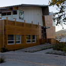 A view of the entrance area to the LEED (Leadership in Energy and Environmental Design) certified Gulf Islands National Park Reserve Operation Centre at dusk, with the harbour in the background.