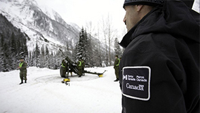 Parks Canada Avalanche Officer, Jeff Goodrich overlooks the Howitzer operation. Photo: Rob Buchanan
