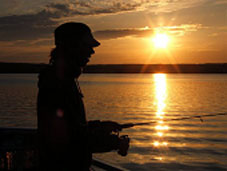 A woman fishing near sunset in Cape Breton Highlands National Park