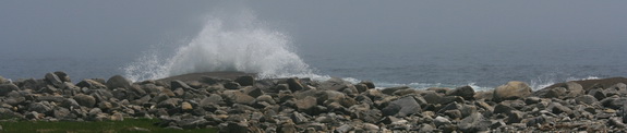 Wave crashing over rocky headlands