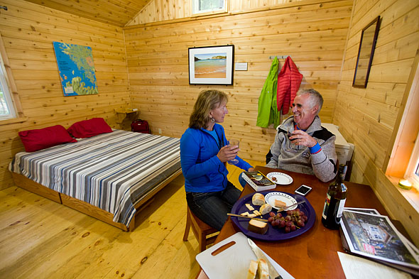 a couple eats inside a cabin